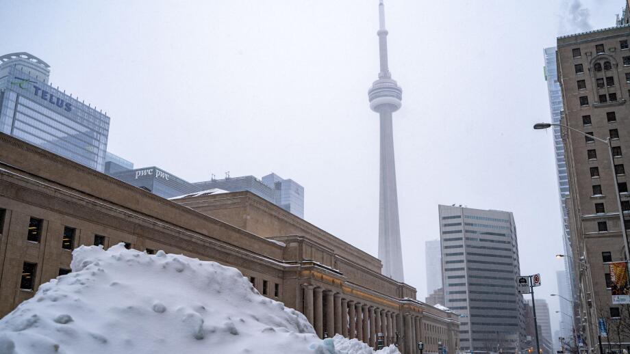 Winter storm view of downtown Toronto. Snow-covered cityscape.