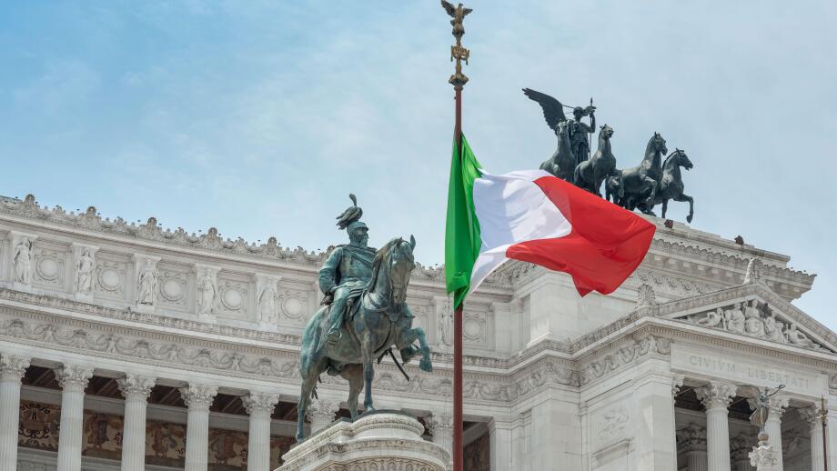 Italy flag city landmark, view of the national flag of Italy sited at the Vittorio Emanuele Monument in the historic centre of Rome, Italy