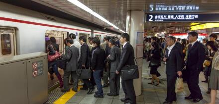 Japanese commuters boarding underground train in Tokyo, Japan