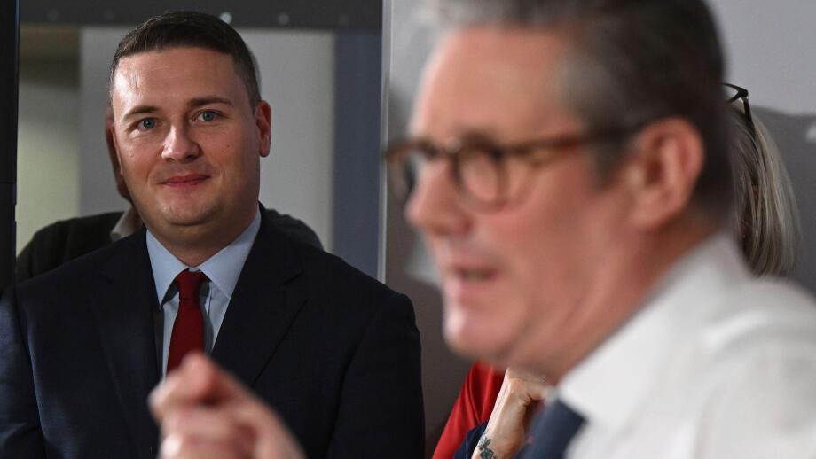 Britain's Health Secretary Wes Streeting, left, watches as Britain's Prime Minister Keir Starmer gives a speech on reducing NHS wait times as he visits a healthcare provider in Surrey, England, Monday, Jan. 6, 2025, (Leon Neal/Pool Photo via AP)