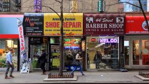 Small business storefronts along East 44th St in Midtown Manhattan, New York, NY. essential small business services that office workers may need.