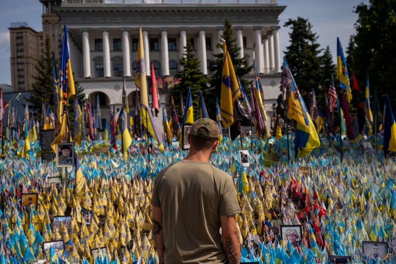 A tattooed man in military fatigues stares at a memorial to individuals killed defending Ukraine during the Russo-Ukrainian War, in Maidan Nezalezhnosti (Independence Square) in Kyiv, Ukraine on July 21, 2024. The war, which began in 2014 and was escalate