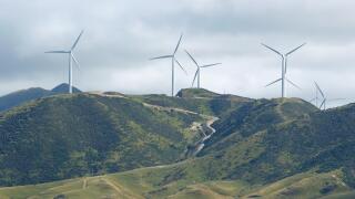 Wind power turbines on green hill near Wellington, New Zealand