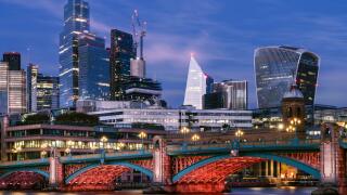 Southwark - London, England. The lights come on along Southwark Bridge at dusk. Crossing the River Thames between Southwark and the City, the arched b
