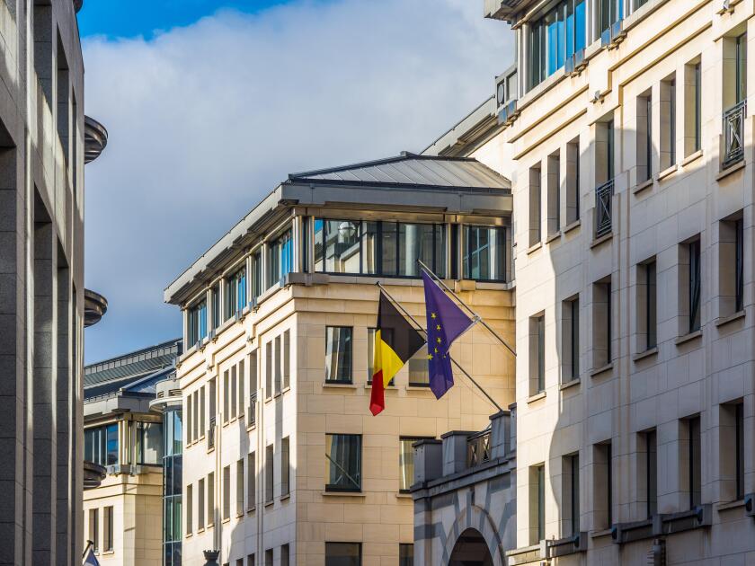 Belgian and EU flags flying on government buildings off Rue de Namur, Brussels, Belgium.