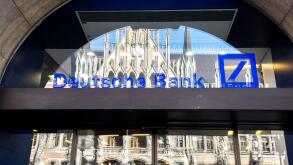 Deutsche Bank logo on the window of a branch in Munich