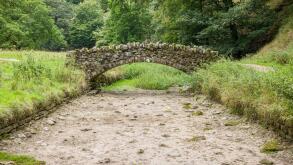 Stone bridge over a dried up riverbed. Drought in Seven Bridges Valley, North Yorkshire, England, UK