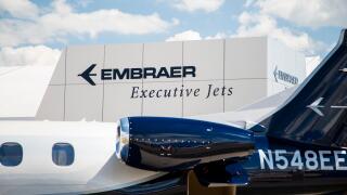 Embraer Executive Jets logo and part of a jet an air show