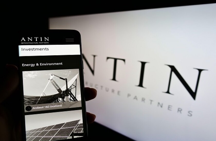 Person holding cellphone with webpage of investment company Antin Infrastructure Partners on screen with logo. Focus on center of phone display.