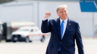 Greenville, S.C., USA - October 15 2020: Donald Trump walking outdoors, raising his fist in a gesture of triumph