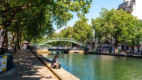 Paris, France, 04.28.2025 People enjoying a warm day on the banks of Canal Saint Martin in the 10th arrondissement of Paris