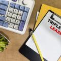 Concept of Triple Net Lease write on paperwork isolated on Wooden Table.