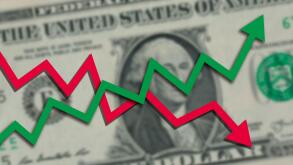 Blurred one US dollar bill with green stock market chart arrow going up and red arrow going down. Dollar exchange rate going both up and down concept.