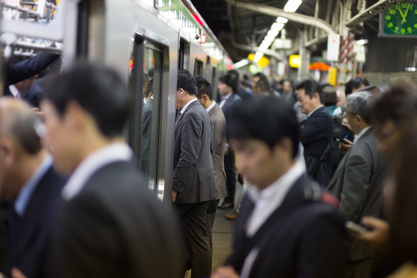 Passengers traveling by Tokyo metro.