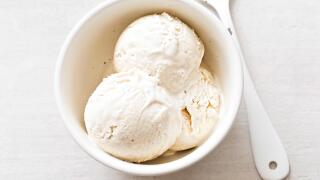 Vanilla ice cream scoops in white bowl