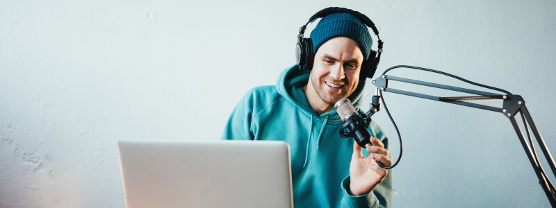 Handsome content creator streaming his live podcast using profes