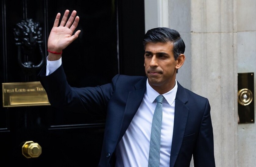 New British Prime Minister Rishi Sunak gestures outside 10 Downing Street, London. ?Right now our country is facing a profound economic crisis" Sunak said after becoming the first person from an ethnic background to lead the British government and its you