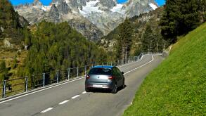 Car on mountain road, Susten Pass, Uri Alps, Canton of Bern, Switzerland