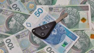 Car keys on Polish zloty banknotes background closeup