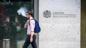 London Stock Exchange LSE - A city worker exhales vapour while passing the London Stock Exchange offices in the City of London, UK
