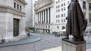 A view of Wall Street from the steps of the Federal Hall on a sunny day in New York, NY.