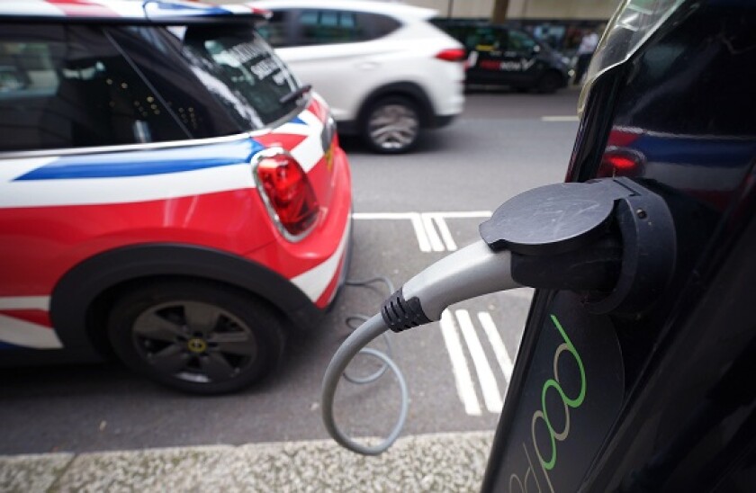 A MINI Electric car is plugged into a public Pod Point charging point on a street in central London. Picture date: Monday August 2, 2021.