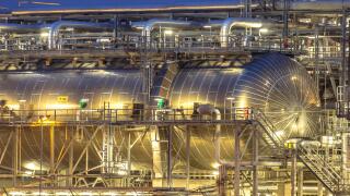 Giant container in Chemical factory at night. Petrochemical background.