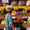Housewife Browsing Outside A greengrocers Fruit and Veg Shop Display UK