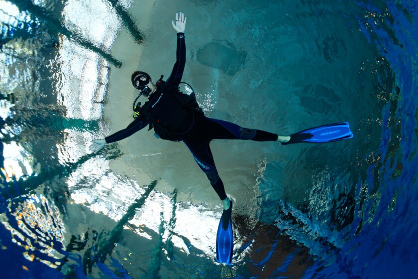 Dive training, scuba diver with outstretched arms and legs, balancing, in a swimming pool, Nuremberg, Bavaria, Germany
