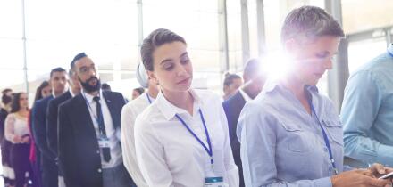 Business people standing in queue in lobby