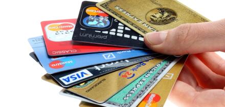 Hand holding a fan of of credit cards, bank cards