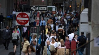 Looking west along Wall Street during the morning rush hour by the New York Stock Exchange in Manhattan. Image shot 2007. Exact date unknown.