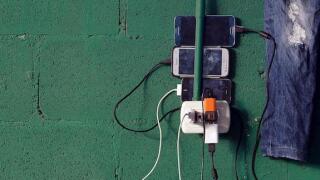 Cuban migrants charge their phones at a temporary shelter in a school in the town of La Cruz, Costa Rica, near the border with Nicaragua, November 17, 2015. More than a thousand Cuban migrants hoping to make it to the United States were stranded in the bo