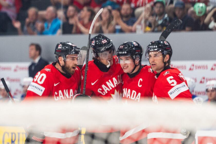 FRIBOURG, FRIBOURG - MAY 28: Canada players celebrate for the first time after Macklin Celebrini scored during the 2026 IIHF World Championship quarterfinal match between Canada and the United States at BCF Arena on May 28, 2026 in Fribourg, Fribourg, Swi