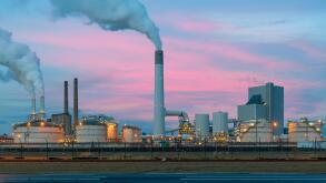 Smoke emission from factory pipes of oil refinery in night, Netherlands. Emission environment from oil refinery.