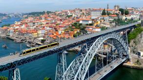 Metro train crossing the Douro River over Dom Luis I Bridge, Porto, Portugal