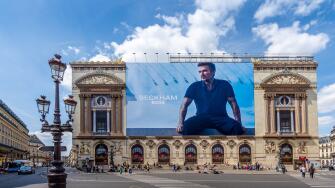 Advertising billboard for the Beckham - Boss clothing collection, by Hugo Boss, over the restoration works on the main facade of the Paris Opera house