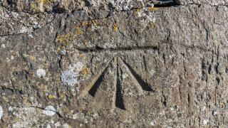 Old surveyors benchmark in stone structure