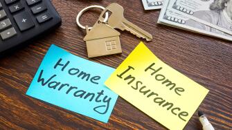 Home warranty vs home insurance and key on the desk.