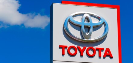 Toyota logo on car dealership sign.