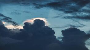Iridescent Pileus Cloud. Rainbow cloudy. dark sky scape nature background. Big sky.
