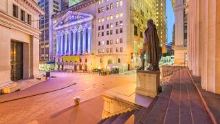 New York City in the Financial District on Wall Street at night.