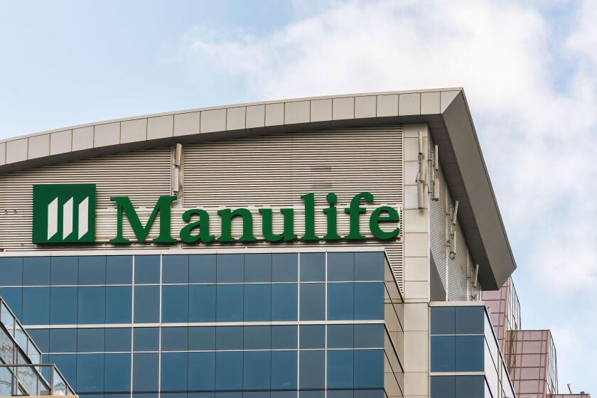 Sign and logo of Manulife Financial Corporation on top of a modern  building in the downtown district. Nov. 22, 2021