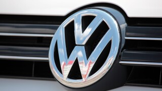 Close-up Volkswagen emblem on a Golf 6 (Mk VI) car.