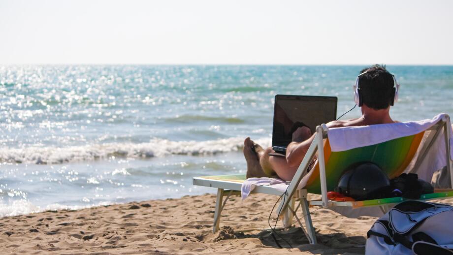 Remote Working Concept - Man at work from the beach
