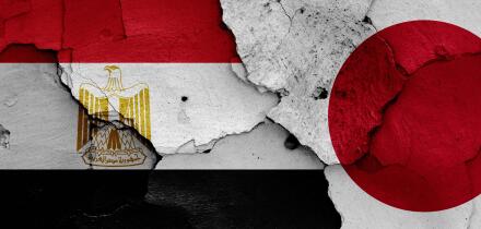flags of Egypt and Japan painted on cracked wall