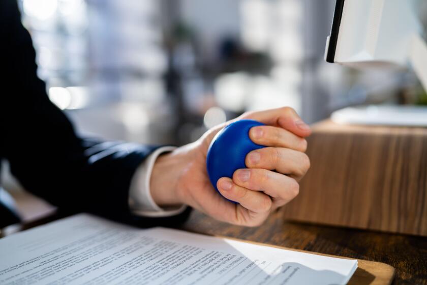 Close-up Of Businessman Holding Stress Ball