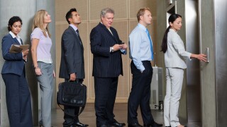 Businesspeople waiting in queue for elevator