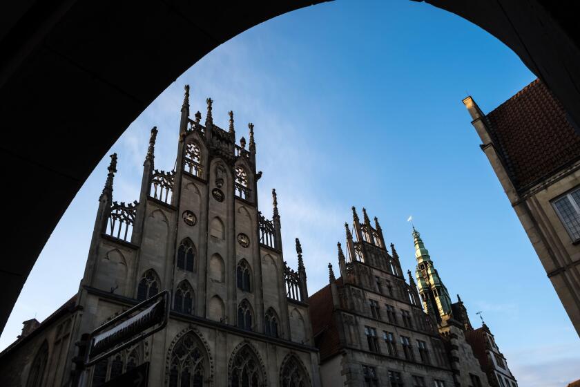 Architectural detail of the historic city center of Munster in North Rhine-Westphalia. In the background, the historical City Hall of Munster.