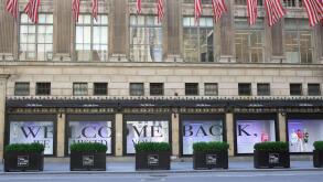 Saks Fifth Avenue department store welcome back sign in windows for reopening in Phase 3 during COVID-19 pandemic, Midtown, Manhattan, New York City, USA July 2020
